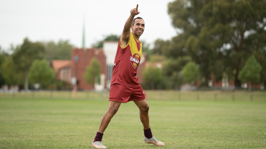 AFL footballer Eddie Betts with his hand in the air
