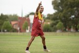 AFL footballer Eddie Betts with his hand in the air