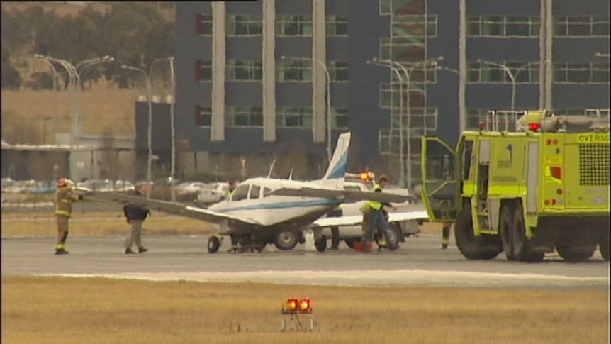 A plane landing with minor front damage briefly closed the runways at Canberra airport.