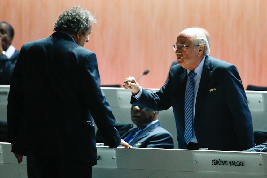 Sepp Blatter speaks with Michel Platini.