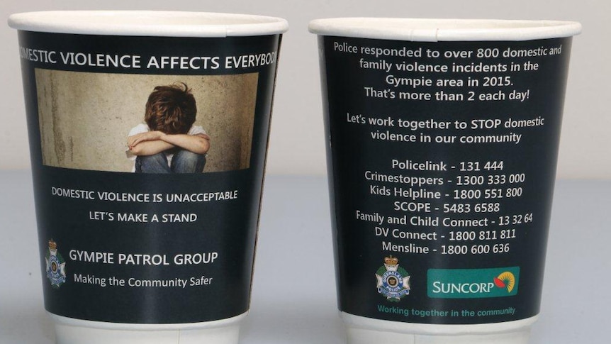 Takeaway coffee cups printed with domestic violence message and information