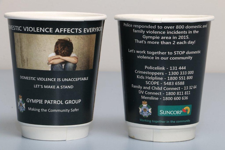 Takeaway coffee cups printed with domestic violence message and information