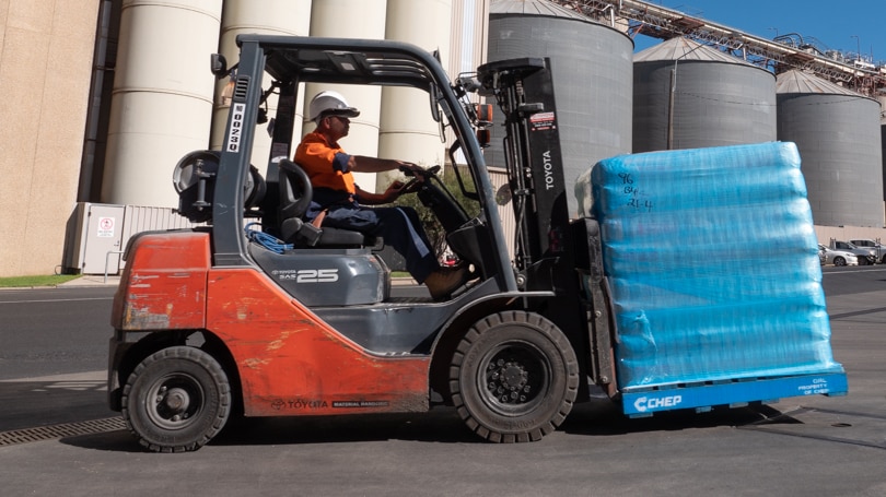 A forklift carrying bags of flour