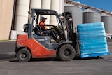 A forklift carrying bags of flour