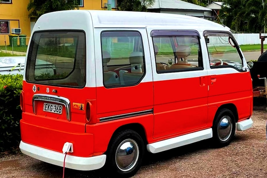 An orange VW Kombi parked at a charging point.