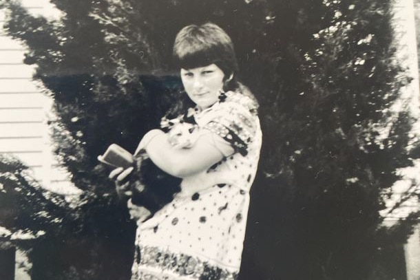 A woman holding a cat.