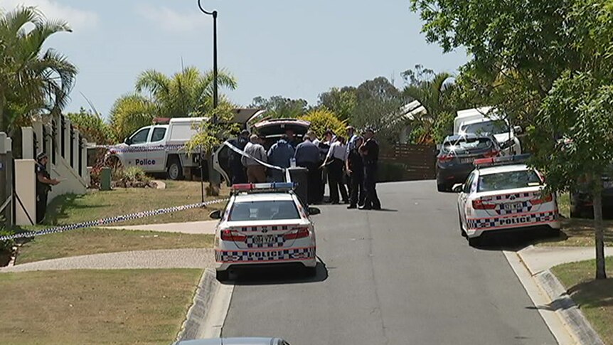 Police officers and vehicles at the scene where Radica Zafirovska was found bludgeoned to death in her home at The Gap.