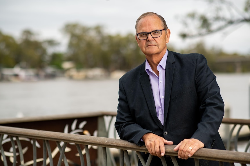 Man stands in front of river 