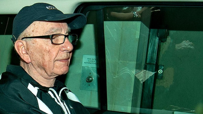 News Corporation Chief Rupert Murdoch leaves his London home in a car
