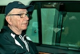 News Corporation Chief Rupert Murdoch leaves his London home in a car