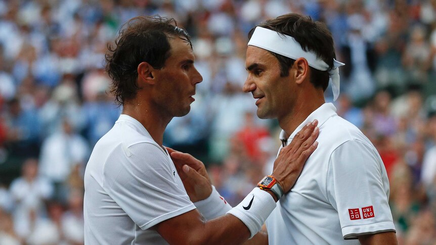 Rafael Nadal puts his hand on Roger Federer's shoulder after their Wimbledon match