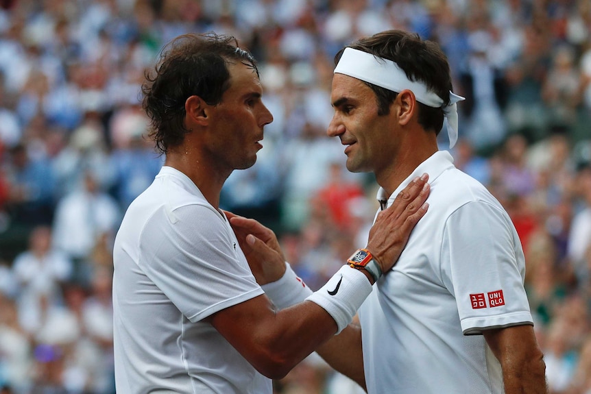Rafael Nadal puts his hand on Roger Federer's shoulder after their Wimbledon match