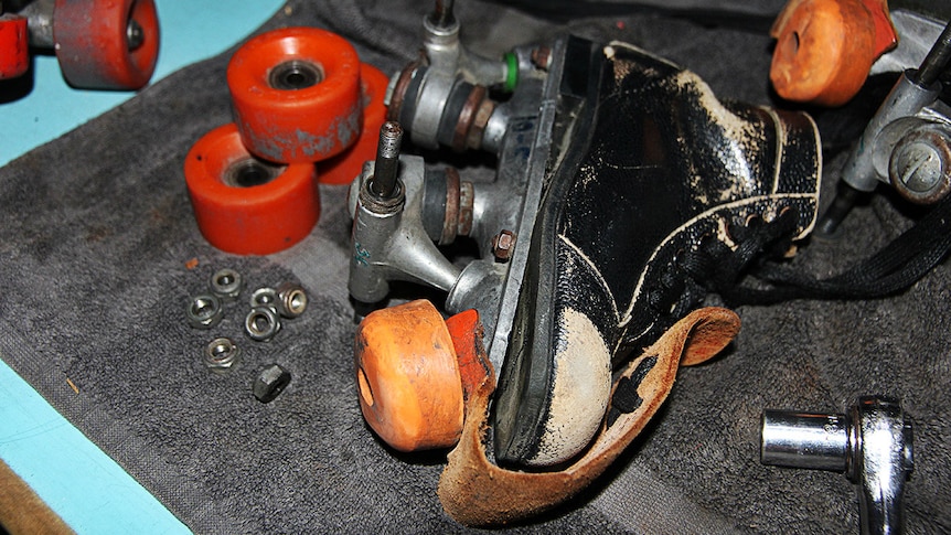 A dismantled roller skate on a repair table