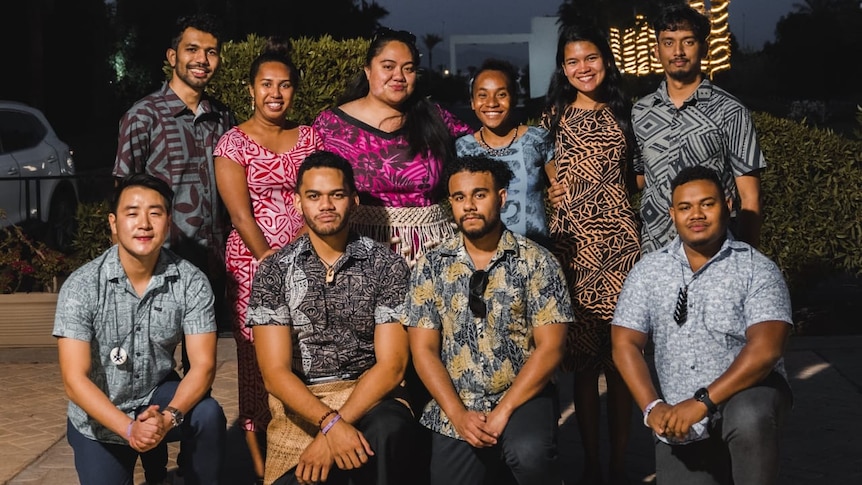 Group of young Pacific men and women posing for photo
