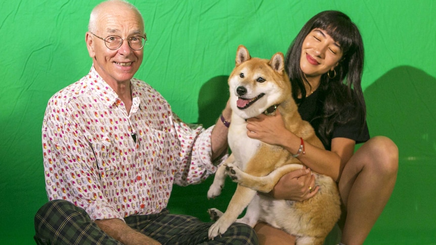 Dr Karl and Linda on a green background posing with a Shiba dog