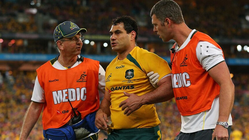 Head knock ... George Smith leaves the field against the Lions for medical attention