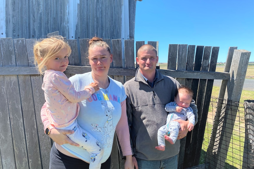 A young family near their front fence