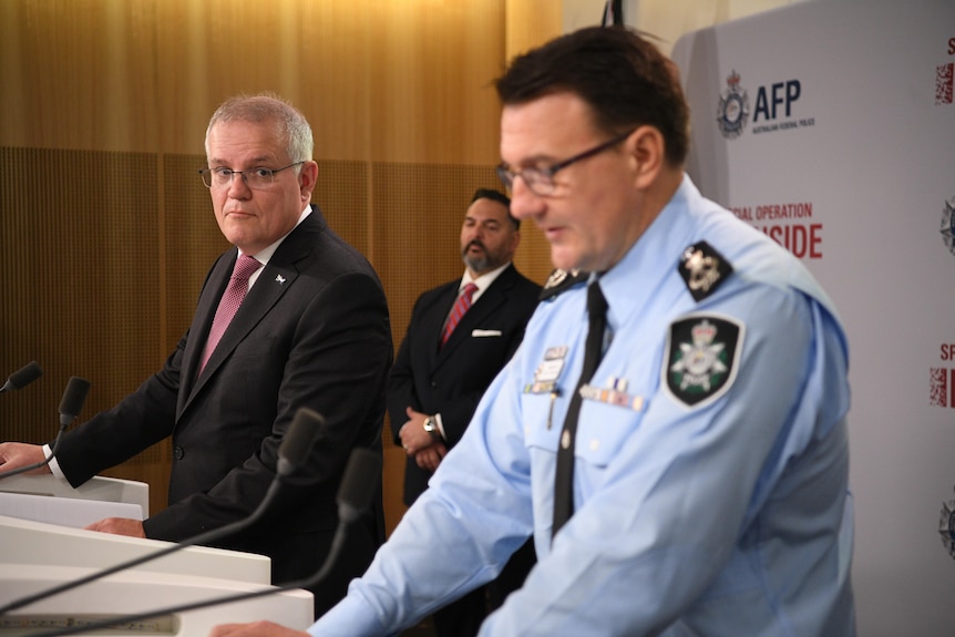 Reece Kershaw addressed the media as Scott Morrison looks on.