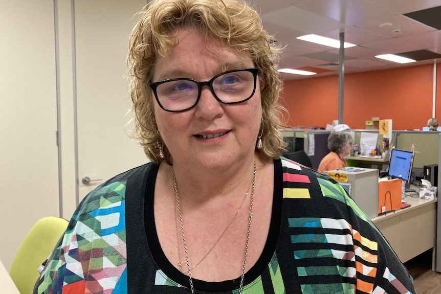 Karyn Walsh stands in an office.