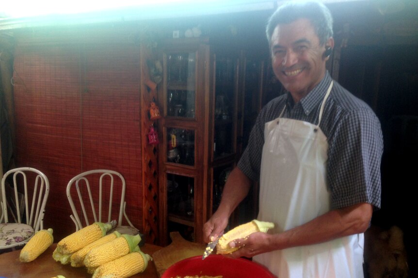Humberto prepares the corn