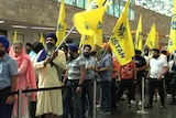 A queue of people holding pro-Khalistan flags