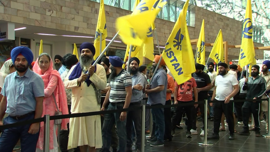 A queue of people holding pro-Khalistan flags