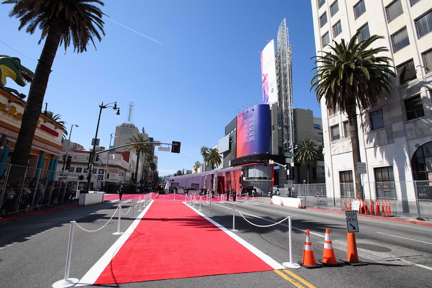 A far shot of the Dolby Theatre set up for the Oscars, with red carpet and partitions on the road.
