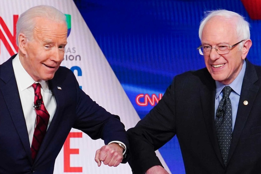 Joe Biden and Bernie Sanders bump elbows at the debate