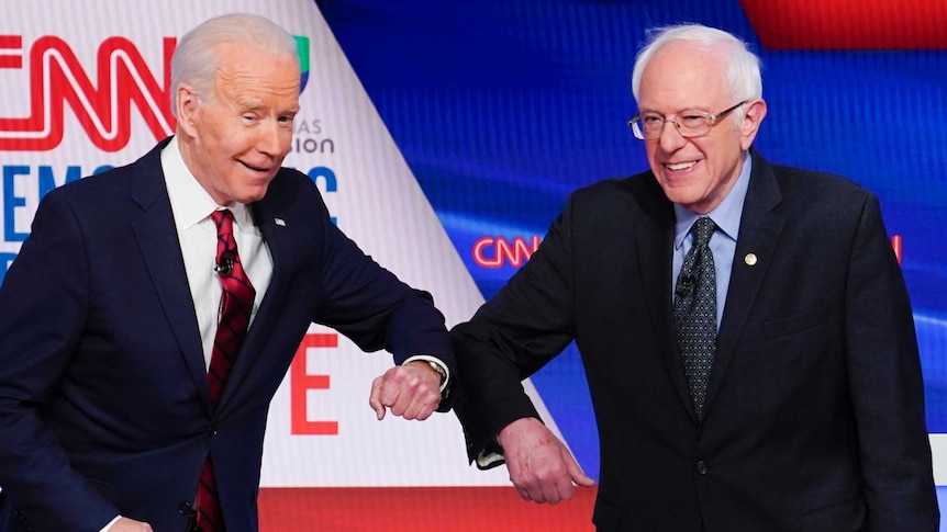 Joe Biden and Bernie Sanders bump elbows at the debate