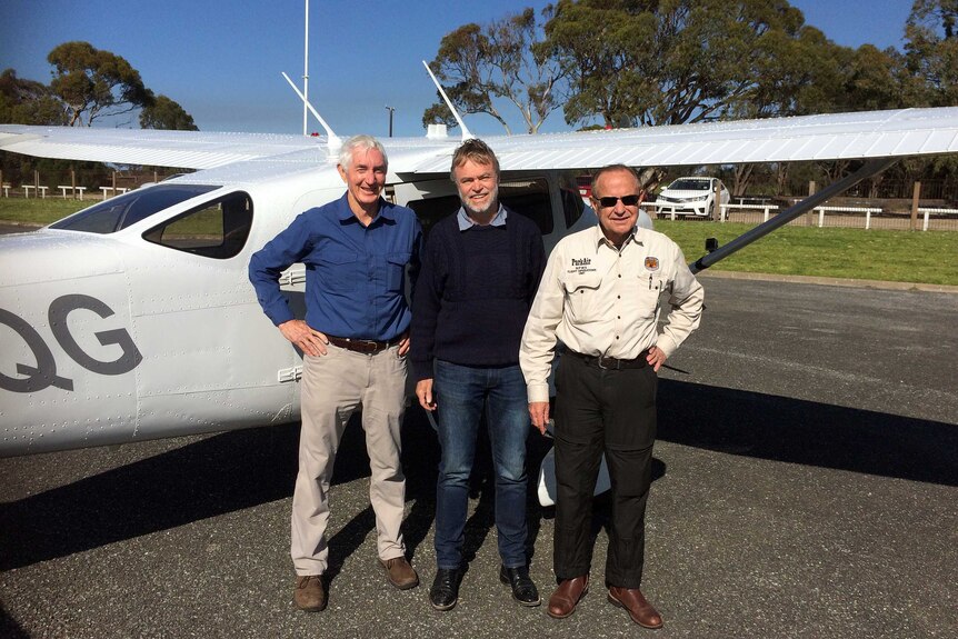 Terry Korn, Professor Richard Kingsford and Richard Byrne in front of a plane.