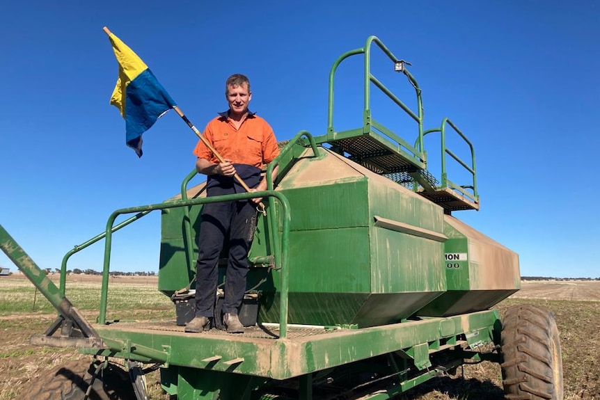 Man standing on air cart with the Ukraine flag