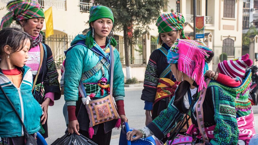 Hmong women selling in town in traditional garb