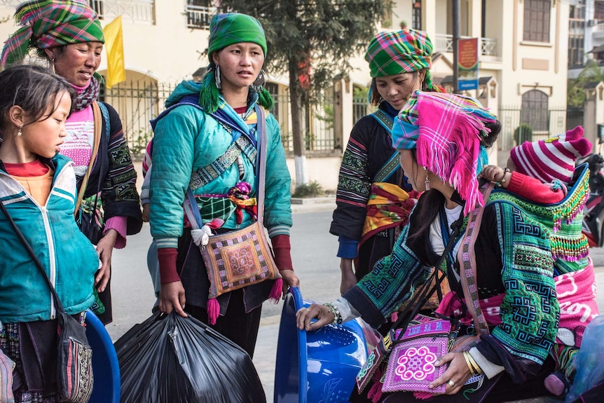 Hmong women selling in town in traditional garb