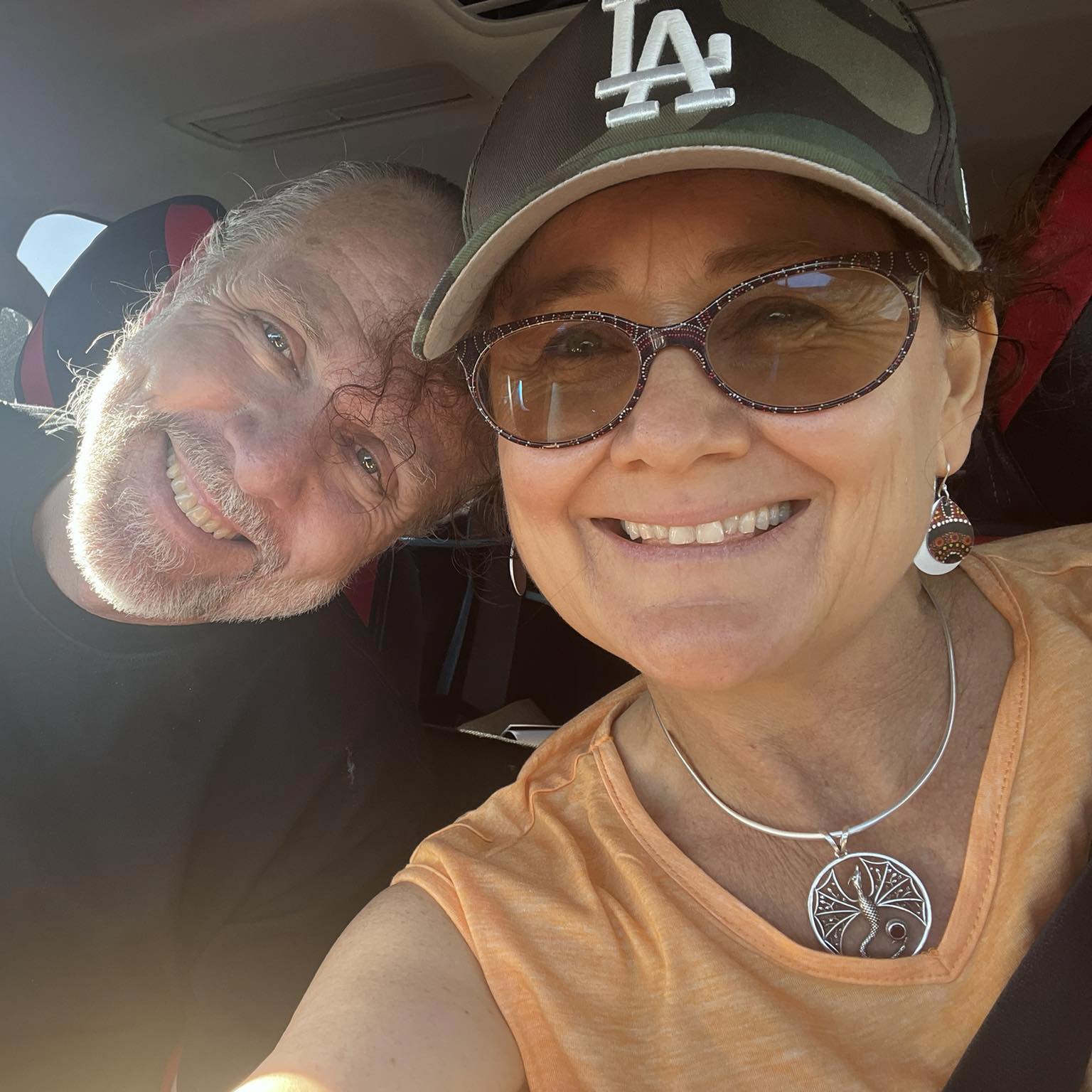 A close-up selfie photo of a man and a woman aged in their 50s.