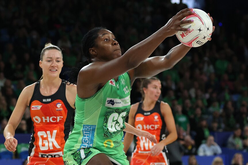 A West Coast Fever Super Netball player catches the ball against the Giants.