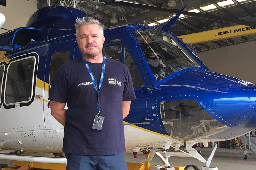 Air Crewman Rick Harvey standing in front of the Sunshine Coast Lifeflight Rescue Helicopter