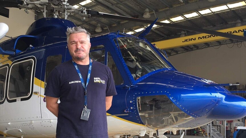 Air Crewman Rick Harvey standing in front of the Sunshine Coast Lifeflight Rescue Helicopter