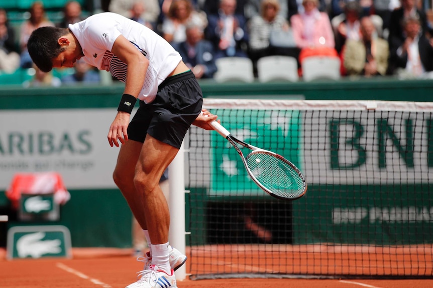 Novak Djokovic slumps during a loss to Dominic Thiem