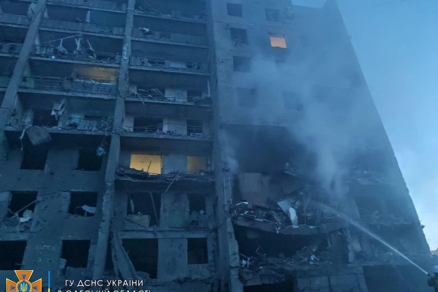 first responders try to extinguish flames at a residential building in Odesa, Ukraine