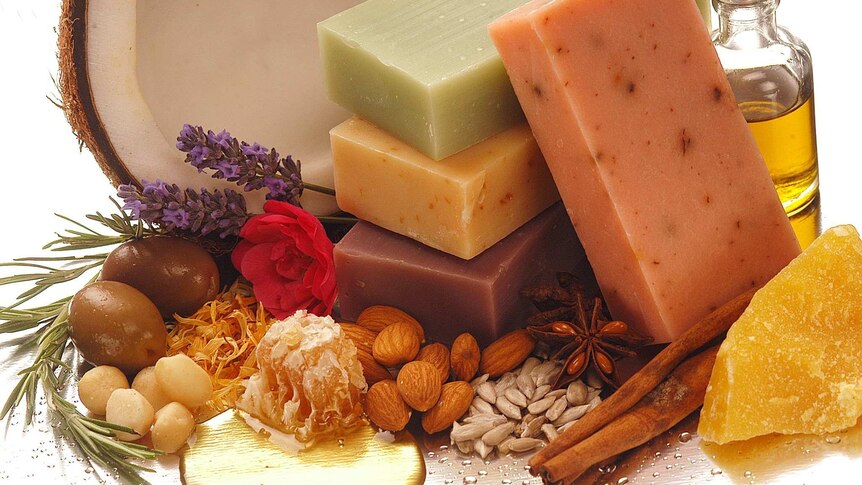 Soap bars surrounded by herbs and food products
