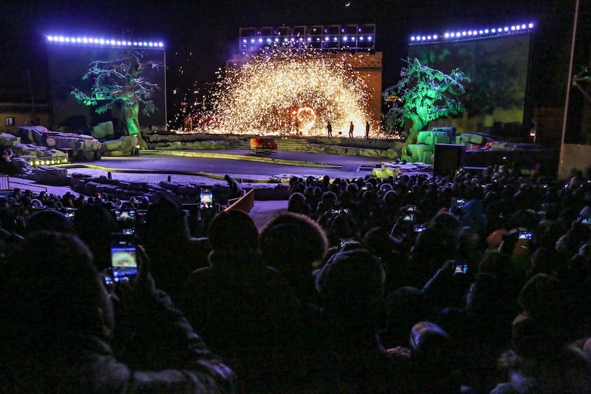 People taking photos of the molten iron fireworks show