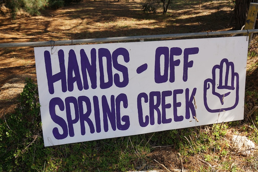 Sign saying Hands off Spring Creek