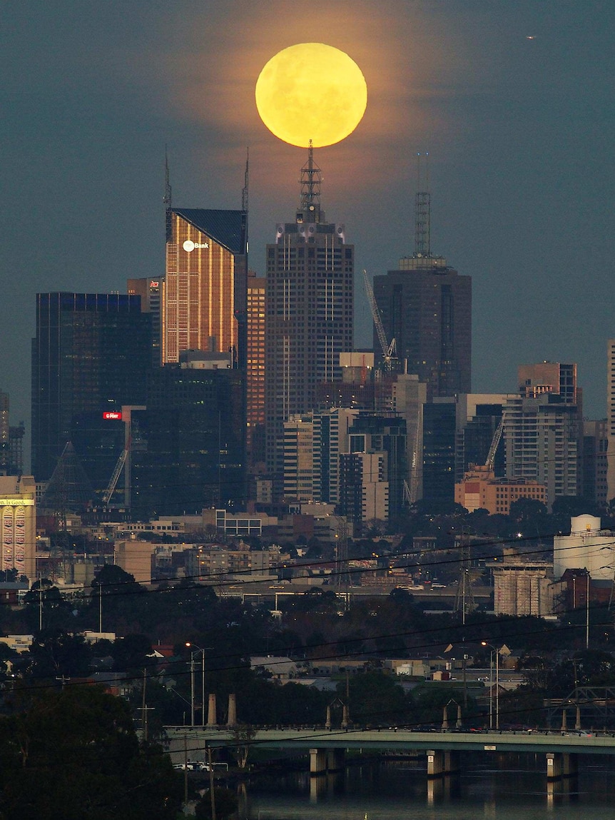 The supermoon rises over Melbourne.