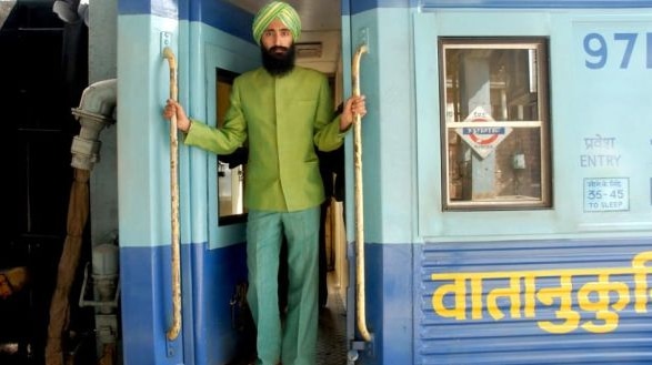 Film still of actor Waris Ahluwalia standing in a train from the film The Darjeeling Limited