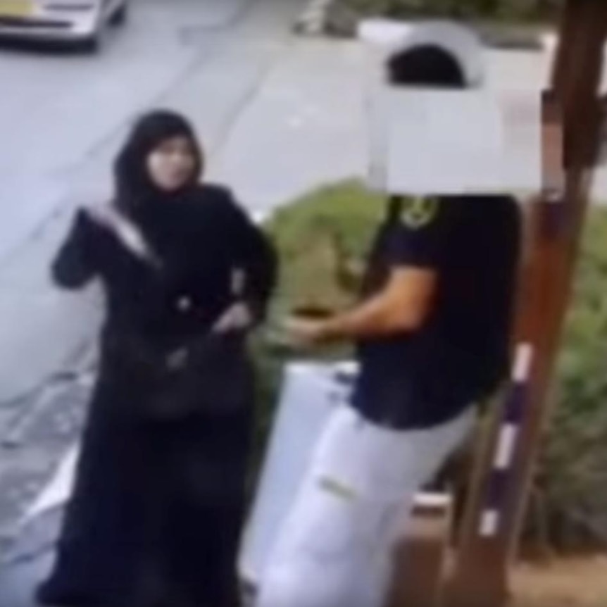 A Palestinian woman pulls a knife from her bag before lunging at an Israeli security guard.