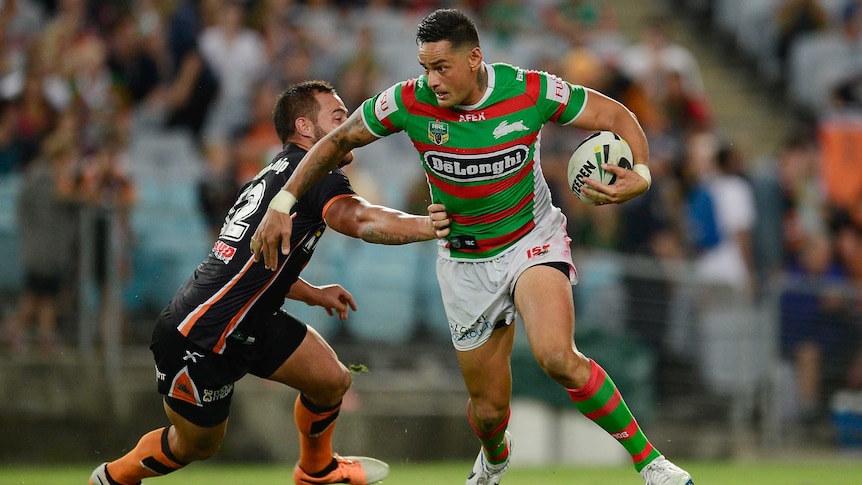 Souths' John Sutton breaks a tackle against Wests Tigers