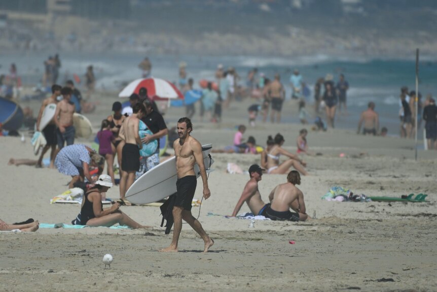 Many people on Trigg Beach, most most are adhering to social distancing rules.