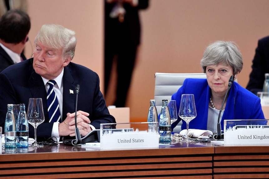 Things look tense between British PM Theresa May and US President Donald Trump as they sit beside each other in hamburg