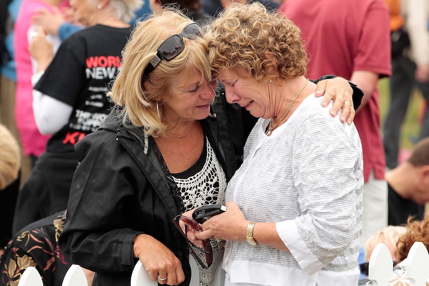Family members grieve during a memorial service on the anniversary of the Christchurch earthquake.