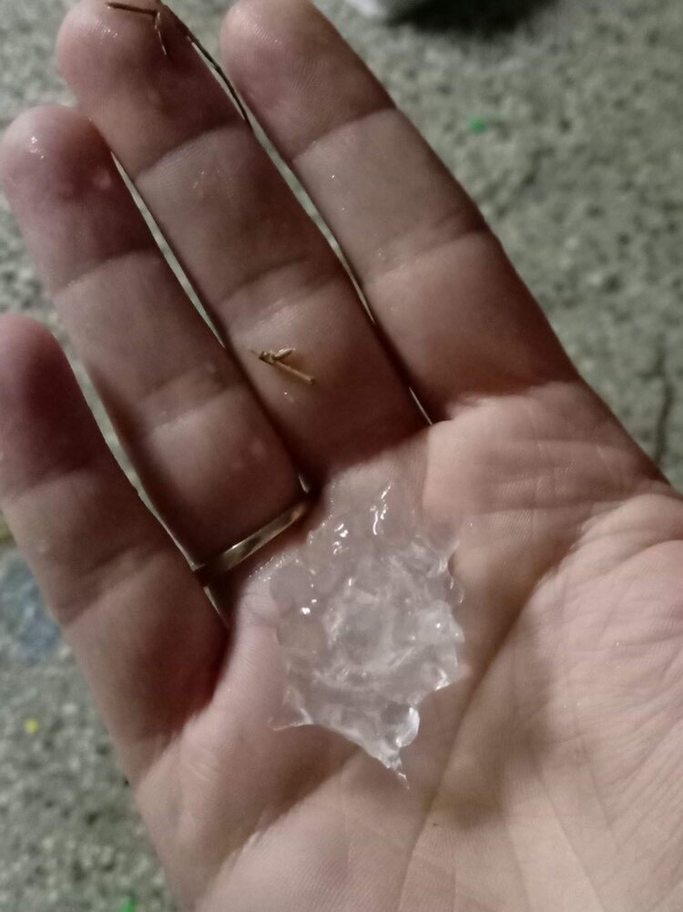 Hail stone in someone's palm.
